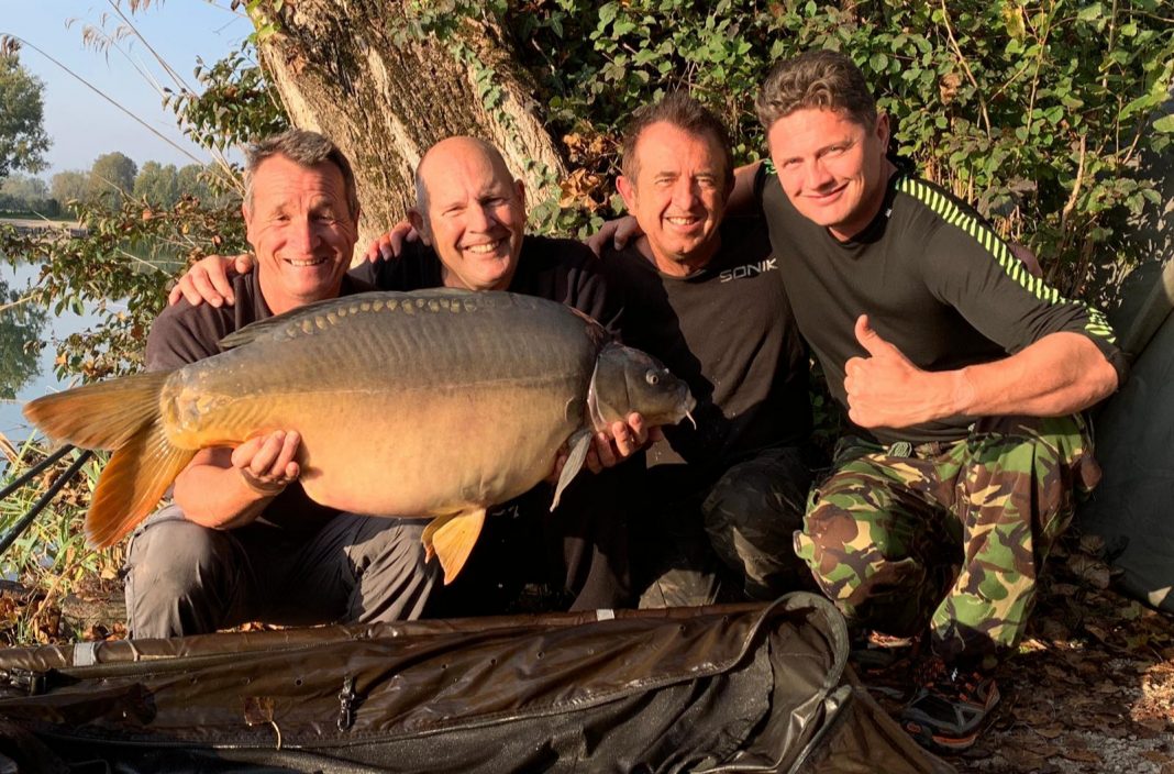 John Fisher (second, left) with a 43lb mirror carp, landed at Parco Del Brenta Lake, Italy.
