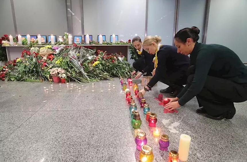 Airline employees lghting candles for the crash victims
