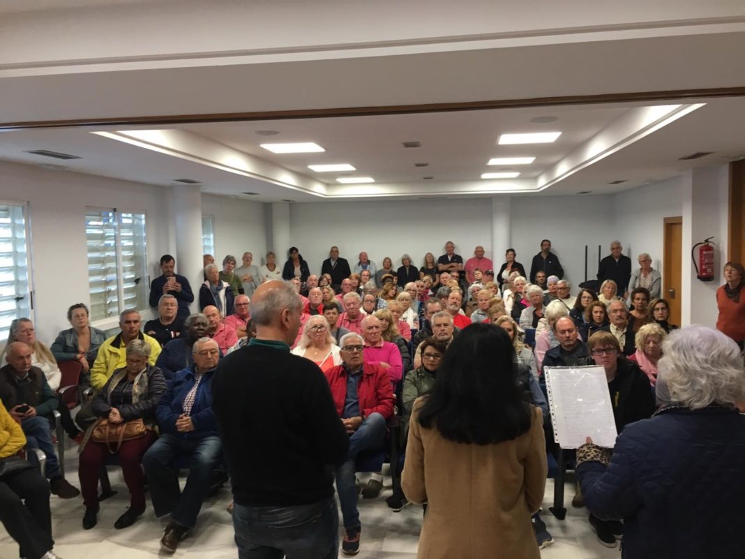 At full to overflowing meeting in in Orihuela Costa Town Hall, Councillor for Sports providing explanations as to delay in reopening fully functioning sports centre