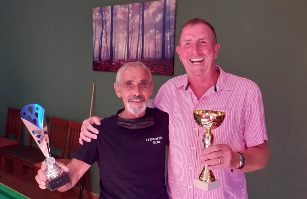 Terry Woolley (OBrien's) and Kim Oswell (Laguna Tavern) with the Mini Winter Pool League runners-up and winner's Trophies. Photo: Helen Atkinson.