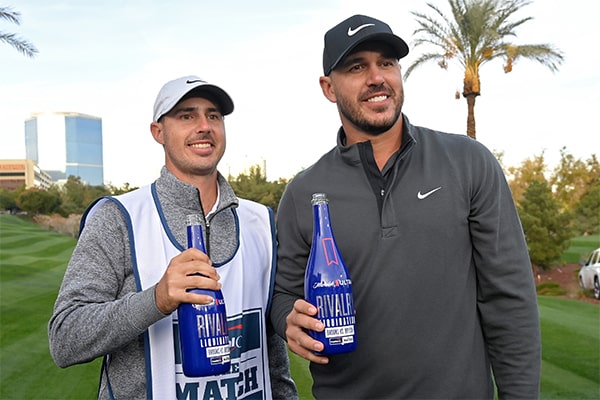Brooks Koepka and his caddie Chase Koepka celebrate after winning The Match (Getty Images)