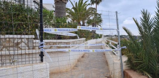 Local residents were aghast on Wednesday when a team of workmen from the Orihuela Ayuntamiento, turned up without any prior notification, and began to close the 100 metres of paseo linking Aguamarina with Cabo Roig. According to a council spokesman the paseo was closed following a sentence imposed by the Supreme Courts, ordering the gates closing it to all but residents of BellaVista Urbanisation, be reinstated, with a deadline of 15 December. The closure will now reintroduce a 3 kilometre diversion for any pedestrian wishing to walk from Aguamarina to Cabo Roig or beyond, many thousands of tourists and residents alike, particularly during the holiday periods. Despite being contacted by The Leader Newspaper, beyond the short 2 line statement stating that the walkway was being closed because of a judicial order, the council have failed to respond. The dispute between the residents of Bella Vista Urbanisation and the Ayuntamiento, relates to a 35 year battle over the Paseo de Cabo Roig, the 100 yard stretch of coastal walkway that runs along the front of the BellaVista Urbanisation, between Aguamarina La Caleta and Cabo Roig Beach. Having initially been declared illegal by both the Administrative Court in Elche and the High Court of Justice, the wall shutting off access was pulled down by municipal staff in March 2015. As he presided over the demolition, Antonio Zapata, Orihuela Councillor for Planning at the time, declared that opening the paseo was long overdue, but what he didn’t reckon on was the resolve of the Bellavista Residents Association. Led by Community President Brian Honess, Bellavista then went back to the courts where they proved to the Judge, Mr Salvador Bellmont Lorente, and to the courts, that the walkway directly along the seawall and in front of the urbanisation has always been private land, and they were completely within their rights to section it off from access to the general public. They argued that the original walkway was actually located at the bottom of the cliff face and not along the top of the urbanisation, as stated by Zapata. The judge had no hesitation in finding with the Residents and he immediately ordered that the wall sealing off the paseo be reinstated. Although the Orihuela Council then had 15 days to appeal, the judgement papers festered in a council drawer, and it seems as though the deadline was allowed to pass with no one in authority being briefed as to the court decision. Former PSOE Councillor, Zapata, said that “the incompetence, neglect and lack of management by Councillors Almagro and Alvarez meant that at the time the council had lost the right to appeal to the Supreme Court.” He added that he still felt “there were more than sufficient arguments as the pathway fell within the protection of the coastal authority.” Cllr Almagro subsequently issued a press release stating he felt that opening the walkway between Aguamarina and Cabo Roig had been a huge mistake. He further clarified that following the Appeal Court Decision, discussions were held between the Provincial Directorate of Coasts and the solicitor who brought the case, Pau Agulló, to assess the judgment following which it was felt that yet another appeal would just add more expense for the city with there being little likelihood of the judgement being overturned. But of course the question now is where do we go from here? With the wall reinstated and Orihuela councillors shifting the blame wherever they can it seems that once again the elected representatives are failing to serve the public interest of those that they represent and the jewel that was once Cabo Roig is now just a murky piece of stained glass!