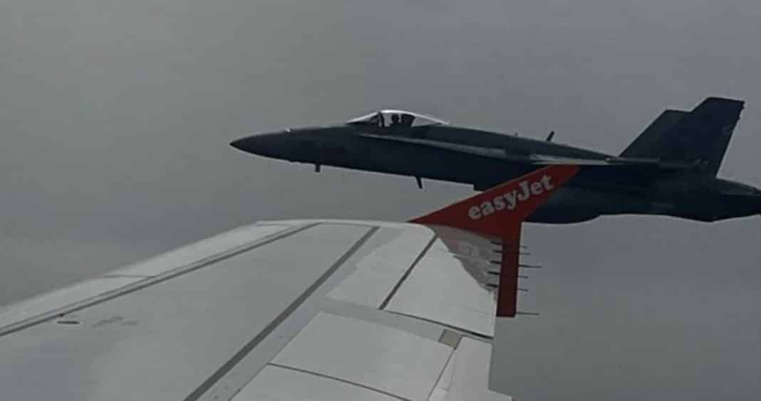 Footage of the incident posted online showed an F-18 jet flying close to the distinctive orange wingtips of the commercial airline's A-319 plane