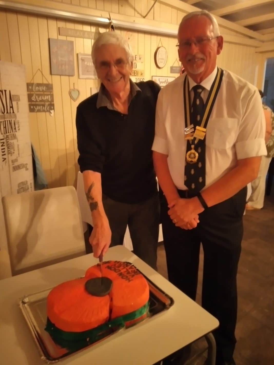 Peter Broadbent – founding member and past President – cutting the cake, with Chairman Joe Logan.