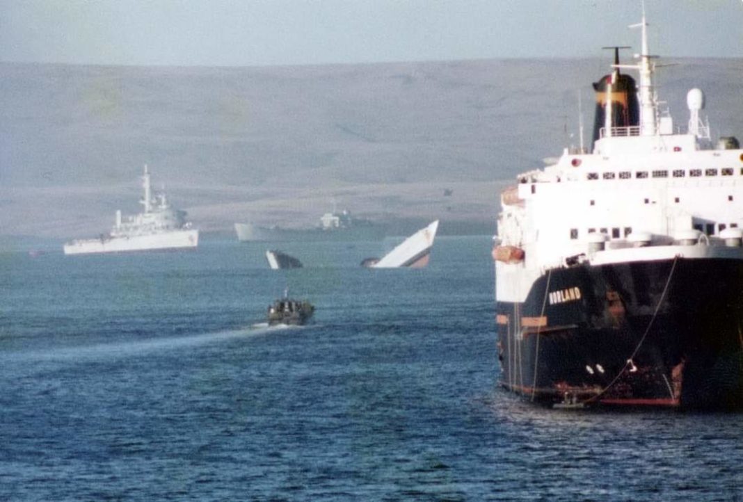 HMS Antelope breaking in two, with the Norland in the foreground.
