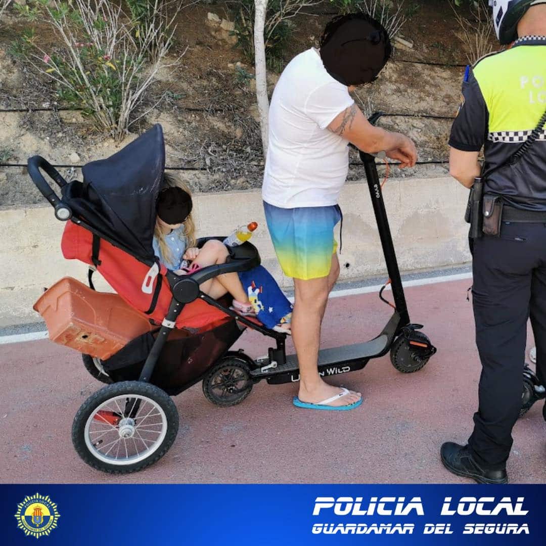 Man stopped in Guardamar towing his daughters pram with an e-scooter