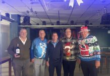 San Miguel Golfers Battle Water, Wind, and Wet Socks Winners pictured L-R: Adrian Roberts (“McBride Bottle”), Mick Pryke (Captain), Dave Rowe (Gold), Robin Eastman (Silver) and Barry “BTB” Roehrig, who absolutely smashed Best Dressed Elf honours. Also pictured are Sandra Dibble and Colin Smith with Nicky and some of her brilliant volunteers from A Helping Hand.